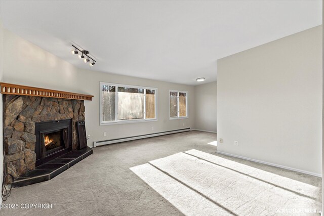 355 Donna Dr # 18, Anchorage, AK 99504 - unfurnished living room featuring a fireplace, track lighting, baseboard heating, and carpet floors
