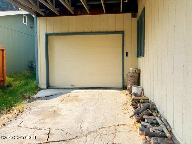 garage featuring visible vents and driveway