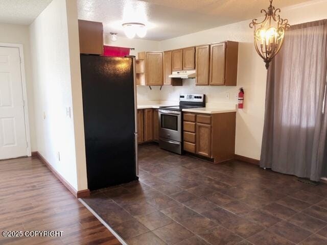 kitchen featuring light countertops, stainless steel range with electric cooktop, freestanding refrigerator, baseboards, and under cabinet range hood