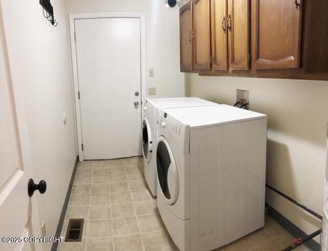 laundry area featuring light floors, visible vents, cabinet space, and washing machine and dryer