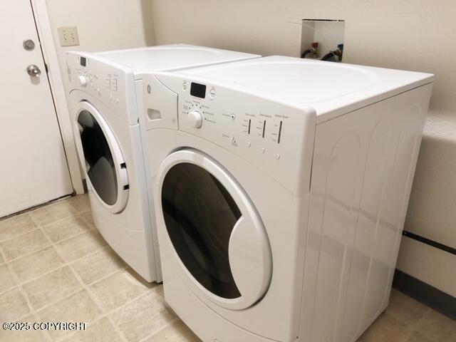 clothes washing area with independent washer and dryer and laundry area