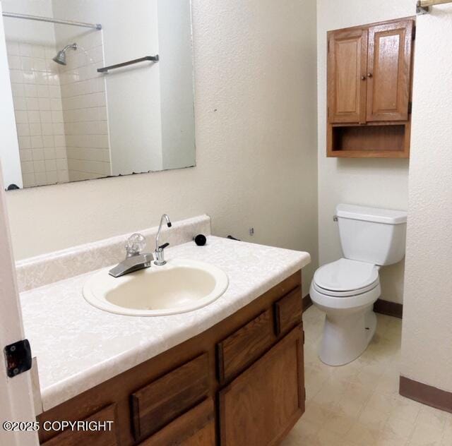 bathroom with toilet, tile patterned floors, walk in shower, and vanity