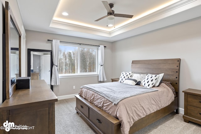 bedroom featuring light colored carpet, recessed lighting, a raised ceiling, and baseboards