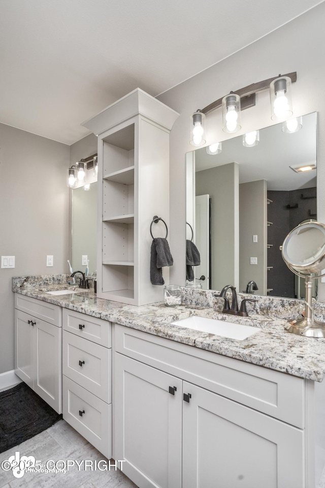 bathroom featuring a sink and double vanity