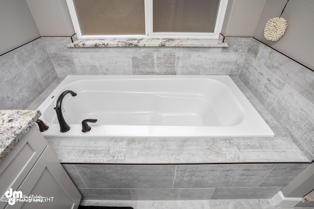 bathroom featuring a bath and vanity