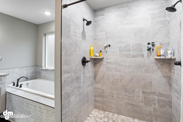 full bath with a garden tub and tiled shower