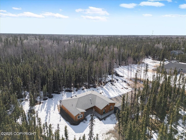snowy aerial view with a view of trees