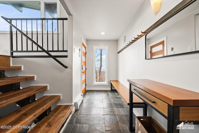 interior space featuring recessed lighting, baseboards, stairway, and stone tile flooring