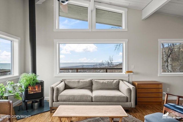 living area featuring lofted ceiling with beams and wood finished floors