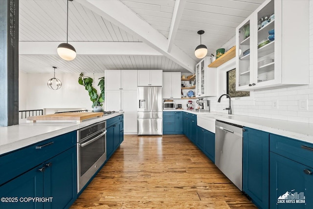 kitchen featuring backsplash, blue cabinets, open shelves, beamed ceiling, and stainless steel appliances
