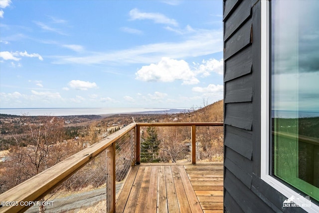 wooden terrace featuring a water view