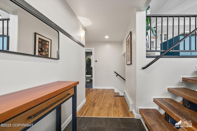 hallway with baseboards, recessed lighting, and baseboard heating