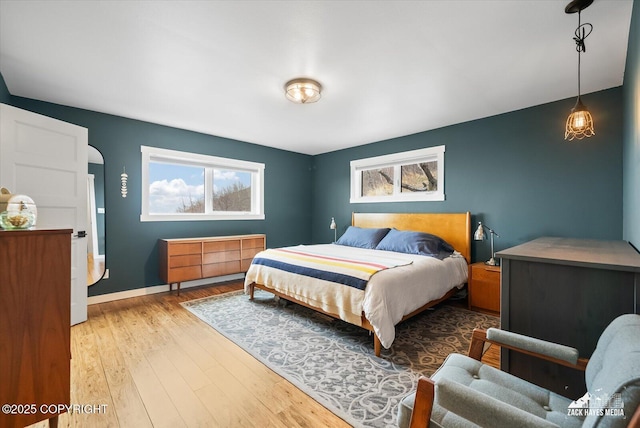 bedroom featuring baseboards and wood finished floors