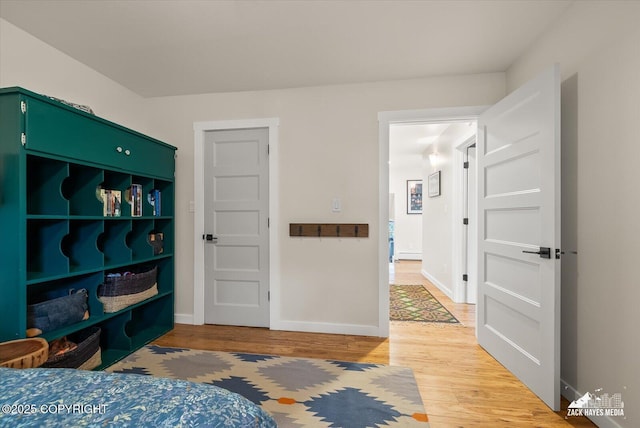 bedroom with baseboards and light wood-type flooring