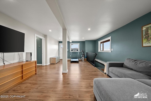living area featuring recessed lighting, baseboards, and wood finished floors