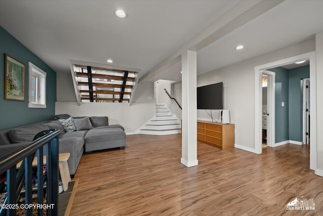 living room featuring recessed lighting, baseboards, stairs, and wood finished floors