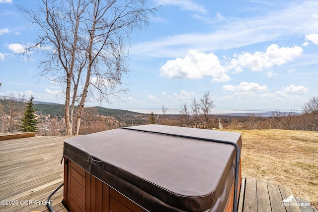 wooden deck with a hot tub