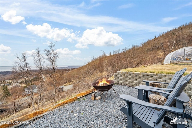 view of patio with an outdoor structure, an exterior structure, and an outdoor fire pit