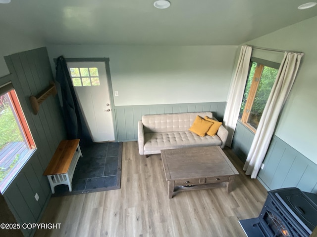 interior space with wood finished floors and a wainscoted wall