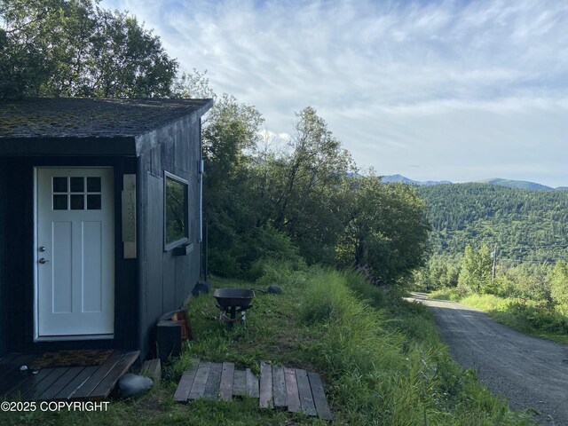exterior space with a mountain view and a wooded view