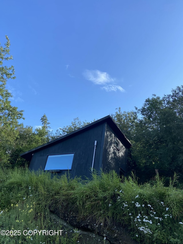 view of side of home featuring a detached garage