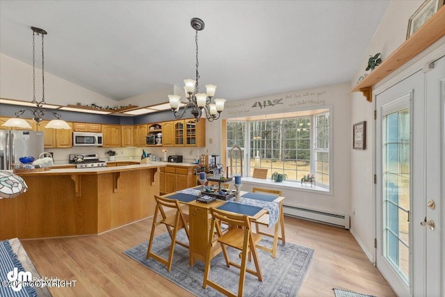 dining room with light wood-style floors, a notable chandelier, vaulted ceiling, and a baseboard radiator