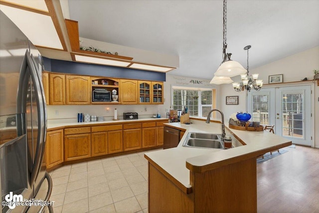 kitchen featuring brown cabinetry, a sink, appliances with stainless steel finishes, and light countertops