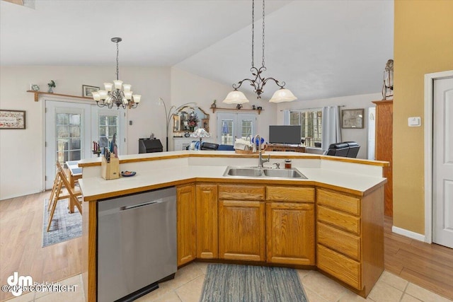 kitchen with a sink, dishwasher, light countertops, a chandelier, and vaulted ceiling