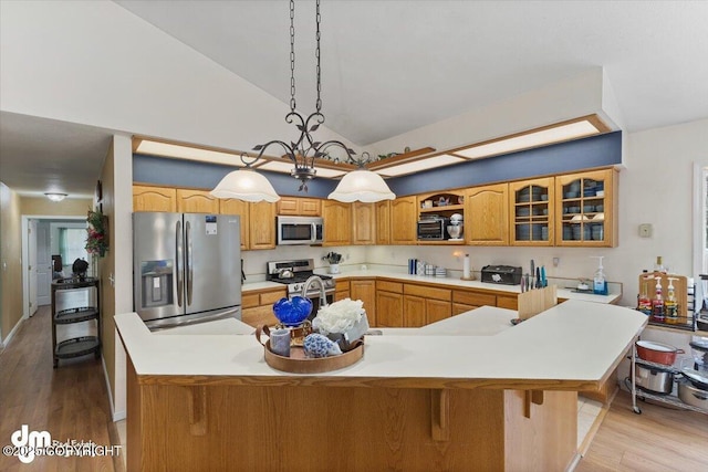 kitchen featuring a kitchen island with sink, stainless steel appliances, high vaulted ceiling, and light countertops
