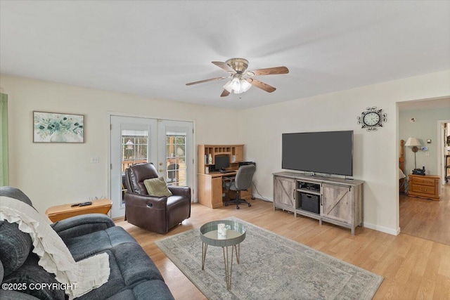 living area featuring french doors, light wood-style flooring, and ceiling fan