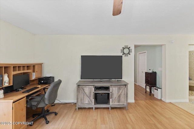 office space featuring light wood-style floors, a ceiling fan, and baseboards
