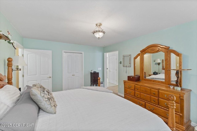bedroom featuring baseboards and a closet