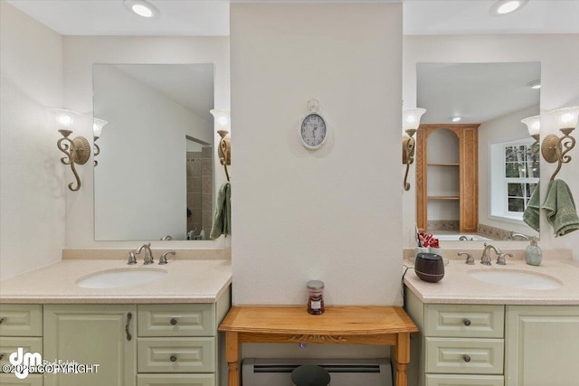 bathroom with a sink, two vanities, and baseboard heating