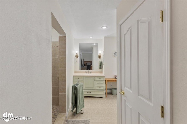 bathroom with vanity, tile patterned floors, and tiled shower