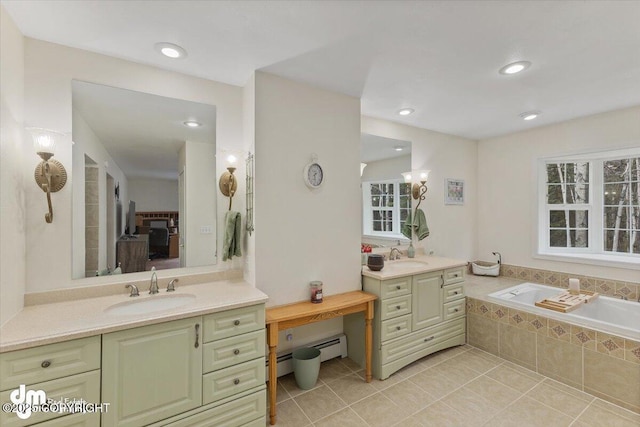 bathroom with tiled bath, two vanities, a sink, and tile patterned flooring