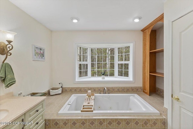 full bath with a jetted tub and vanity