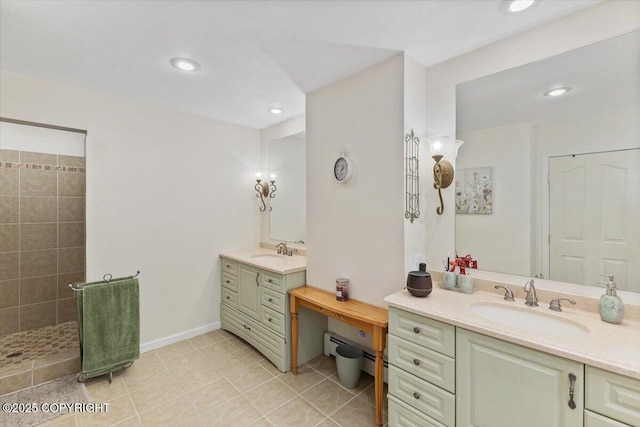 full bath with a sink, a walk in shower, a baseboard radiator, and two vanities