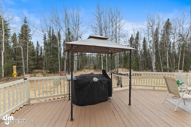 wooden terrace with grilling area and a gazebo