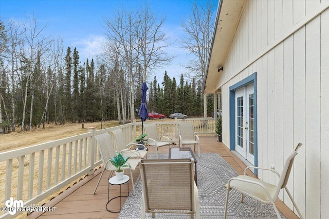 wooden deck featuring outdoor lounge area and french doors