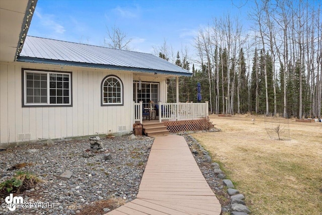 view of front facade with a front yard and metal roof