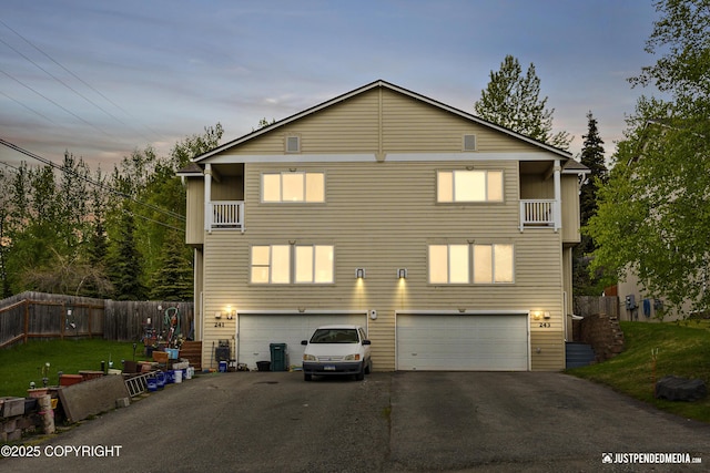 243 Creekside St # 2, Anchorage, AK 99504 - view of front of home with an attached garage, driveway, and a balcony
