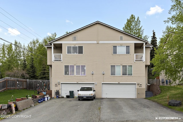 243 Creekside St # 2, Anchorage, AK 99504 - rear view of property featuring a balcony, driveway, and an attached garage