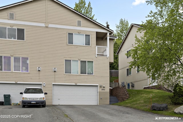 243 Creekside St # 2, Anchorage, AK 99504 - view of front of house with an attached garage and asphalt driveway