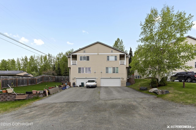 243 Creekside St # 2, Anchorage, AK 99504 - view of side of home featuring an attached garage and asphalt driveway
