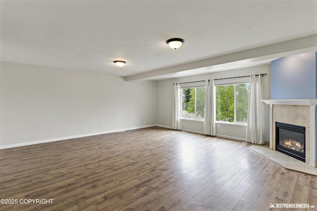243 Creekside St # 2, Anchorage, AK 99504 - unfurnished living room with a fireplace, wood finished floors, and baseboards