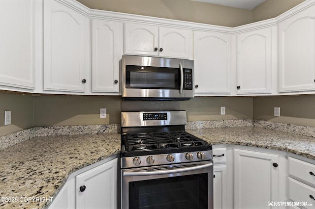 243 Creekside St # 2, Anchorage, AK 99504 - kitchen featuring stainless steel appliances, white cabinets, and light stone counters
