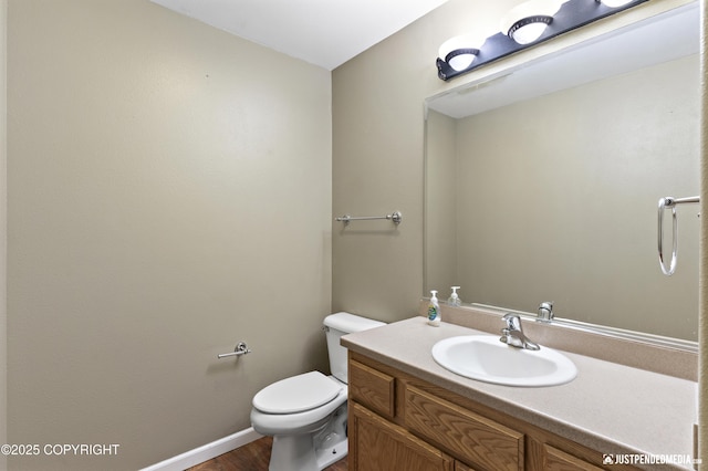 243 Creekside St # 2, Anchorage, AK 99504 - half bath with toilet, vanity, wood finished floors, and baseboards