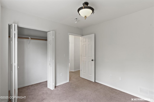 243 Creekside St # 2, Anchorage, AK 99504 - unfurnished bedroom with carpet, a closet, and baseboards