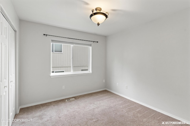 243 Creekside St # 2, Anchorage, AK 99504 - unfurnished bedroom with a closet, carpet floors, and baseboards