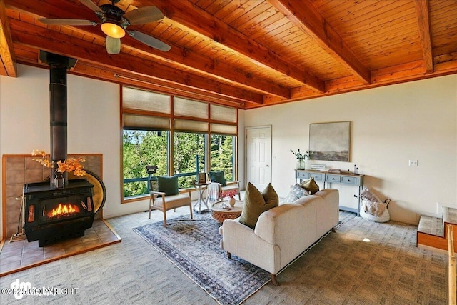 25925 Williamson Ln, Kasilof, AK 99610 - living room featuring a wood ceiling with exposed beams, carpet, a wood stove, and a ceiling fan
